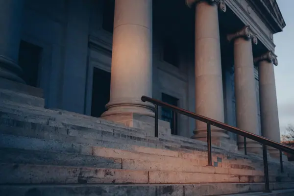Illustration: the steps and columns of a classical courthouse.